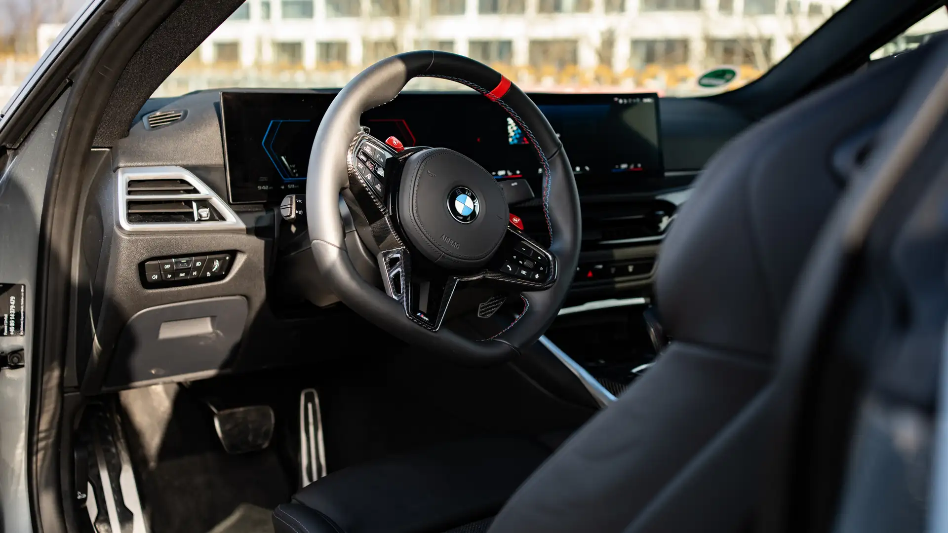 The steering wheel and interior of a BMW M4.